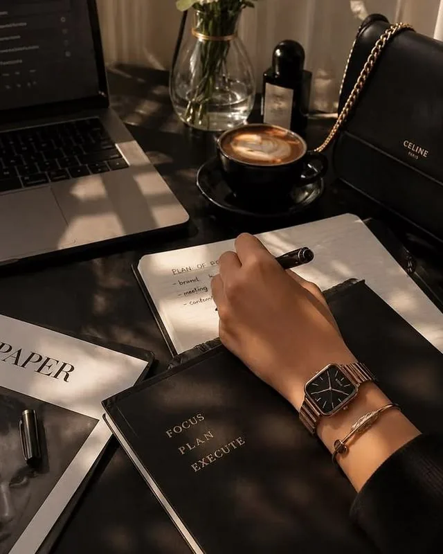 Rania's studio desk — planning a client build, notebook and coffee in hand